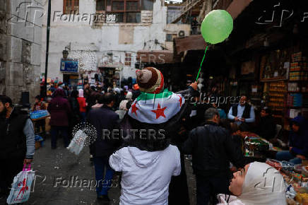 People walk at a traditional souq in the Bab Touma district of the Old City of Damascus