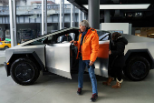 A person gets out of a Tesla Cybertruck at a Tesla showroom in New York City