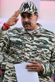 Members of the Bolivarian Militia and supporters of President Nicolas Maduro march to plead allegiance