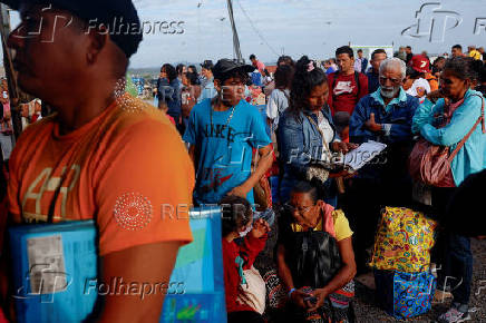 Venezuelans queue to get documentation after leaving Venezuela, at the border, in Pacaraima