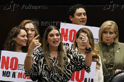 Congress members oppose a reform during a session, in Mexico City