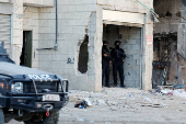 Palestinian security forces patrol amid clashes with militants at the camp in Jenin