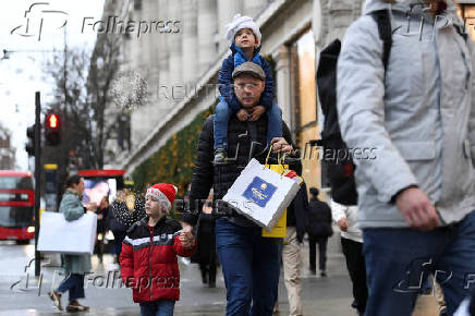 Shoppers walk on Oxford Street in London