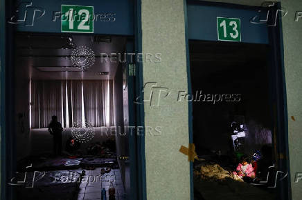 Migrants wait in temporary shelter after CBP One application was shut down, in Matamoros