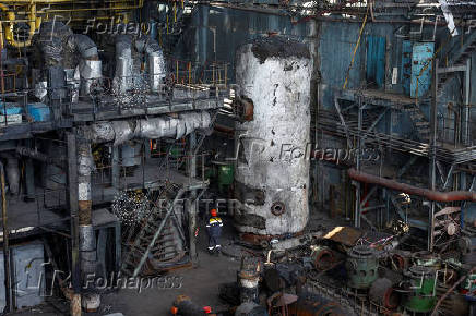 Employee walks at a thermal power plant heavily damaged by recent Russian missile strikes in Ukraine
