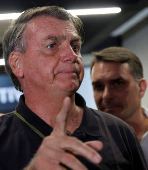 Brazil's former President Jair Bolsonaro talks with media upon his arrival at Brasilia International Airport