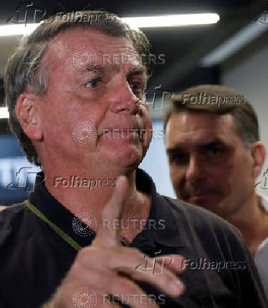 Brazil's former President Jair Bolsonaro talks with media upon his arrival at Brasilia International Airport