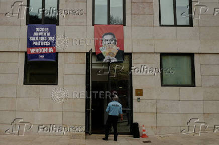 Far-right political party Chega expose banners on the facade of the Portuguese parliament against the wage reinstatement for politicians after the cuts imposed by the Troika, during the debate and vote of the 2025 budget bill on final reading, in Lisbon