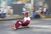 Government supporters participate in a traditional street race with wooden makeshift carts called 