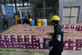 Workers handle boxes of flowers for export before Valentine?s Day, in Quito