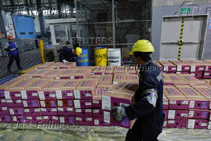 Workers handle boxes of flowers for export before Valentine?s Day, in Quito