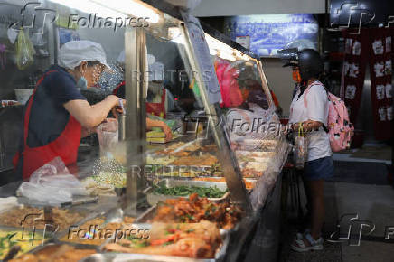 A person picks up food at a restaurant in Keelung