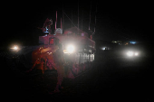 Israeli soldiers gather near a military vehicle after returning from Lebanon, following a ceasefire between Israel and Iran-backed group Hezbollah, near Kiryat Shmona