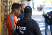 Agents with Homeland Security Investigations (HSI) conduct a search for undocumented migrants in San Juan