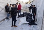 Palestinians mourn their dead after Israeli overnight strike on Rafah camp