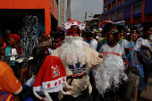 A street vendor sells Christmas hats and Santa Claus beards ahead of Christmas celebration in the district of Adjame in Abidjan