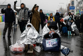 People take part in a protest against the impeached South Korean President Yoon Suk Yeol near his official residence on a snowy day in Seoul