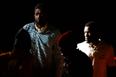 Migrants wait to disembark from a Spanish coast guard vessel, at the port of Arguineguin, on the island of Gran Canaria