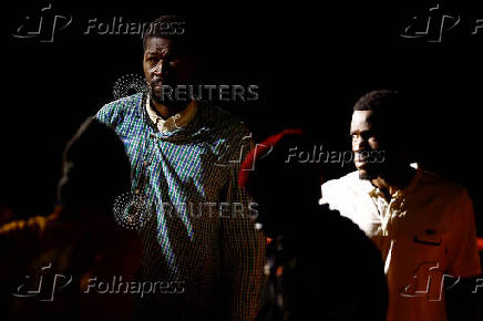 Migrants wait to disembark from a Spanish coast guard vessel, at the port of Arguineguin, on the island of Gran Canaria