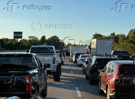 Drivers park on the lanes of the I-75 highway after reports of multiple people being shot while driving down the interstate highway, near London, Kentucky