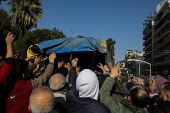 People gather around a truck to receive bread in Aleppo