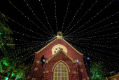 A man installs decorative lights on a church ahead of Christmas celebrations in Ahmedabad