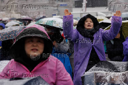 Pro-Yoon protesters attend a rally in support of impeached South Korean President Yoon Suk Yeol near his official residence on a snowy day, in Seoul