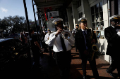 Members of the Perfect Gentlemen Social and Pleasure Club lead a second line parade in New Orleans