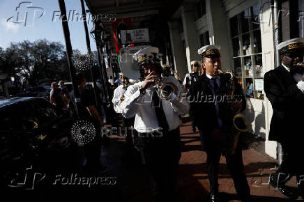 Members of the Perfect Gentlemen Social and Pleasure Club lead a second line parade in New Orleans