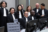 The prosecution team, with Deputy Prosecutor Mame Mandiaye Niang, poses for a group picture in court before the verdict of Al Hassan Ag Abdoul Aziz Ag Mohamed Ag Mahmoud at the International Criminal Court in The Hague