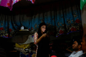 Muskan,16, types on a mobile phone as Tofik and Nasreen look at their daughter at their residence in Loni town in the northern state of Uttar Pradesh