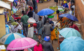 Residents walk at an open air grocery market in the outskirts Kigali
