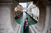 A gondolier rows his gondola through the Venice Canal ahead of Pope Francis's visit, in Venice