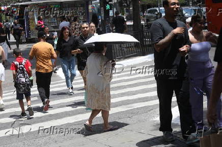 Forte calor faz pedestres se protegerem do sol