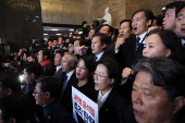 Lawmakers gather to block the entry of South Korean President Yoon Suk Yeol from entering the National Assembly in Seoul