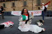 Demonstrators take part in a performance in support of Palestinians, in Mexico City