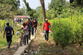 Peasants walk near a coca plantation, after attacks by rebels from the leftist National Liberation Army (ELN) in Tibu