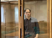 FILE PHOTO: Wall Street Journal reporter Evan Gershkovich stands behind a glass wall of an enclosure for defendants as he attends a court hearing to consider extending his detention in Moscow