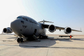 Qatari aid being loaded onto a military cargo plane headed to Syria through Turkey