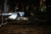 Israeli emergency services work at the scene of a missile strike, in Jaffa, south of Tel Aviv