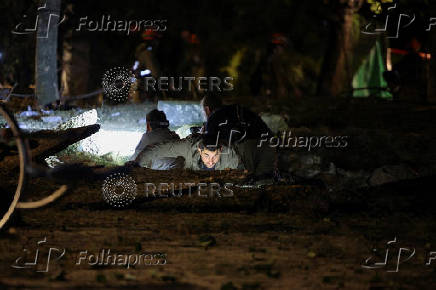 Israeli emergency services work at the scene of a missile strike, in Jaffa, south of Tel Aviv