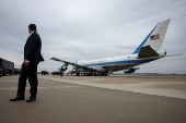 A Secret Service agent looks over as Air Force One prepares to depart to New York from Joint Base Andrews