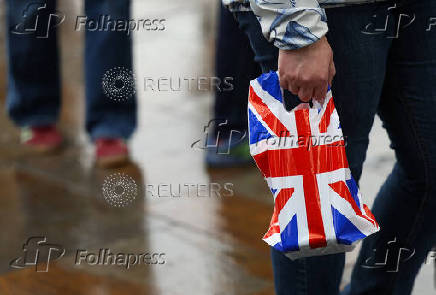 A person carries a British Union Flag design plastic bag in London
