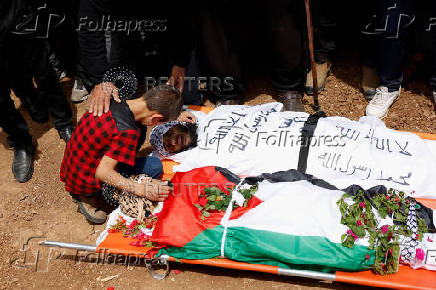 People mourn two Palestinians who were killed during an Israeli settlers' attack on Aqraba
