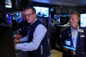 Traders work on the floor of the NYSE in New York