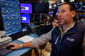 Traders and kids work on the floor of the NYSE in New York