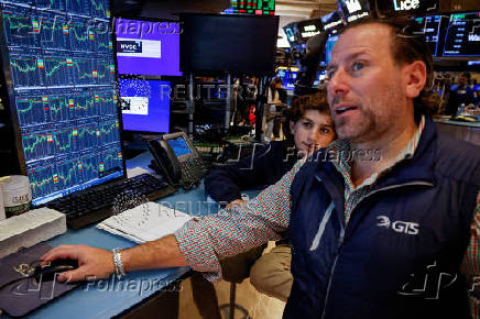 Traders and kids work on the floor of the NYSE in New York