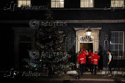 British Prime Minister Starmer and his wife switch on the Downing Street Christmas tree lights, in London