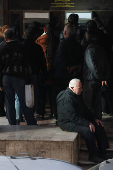 People wait in line in front of ATM, in Damascus