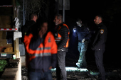 Israeli police bomb squad members work near a damaged site after a projectile fired from Yemen was intercepted, in Ramat Gan